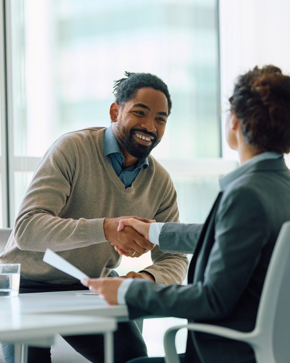 Happy business professional talking to a lady with her back to us
