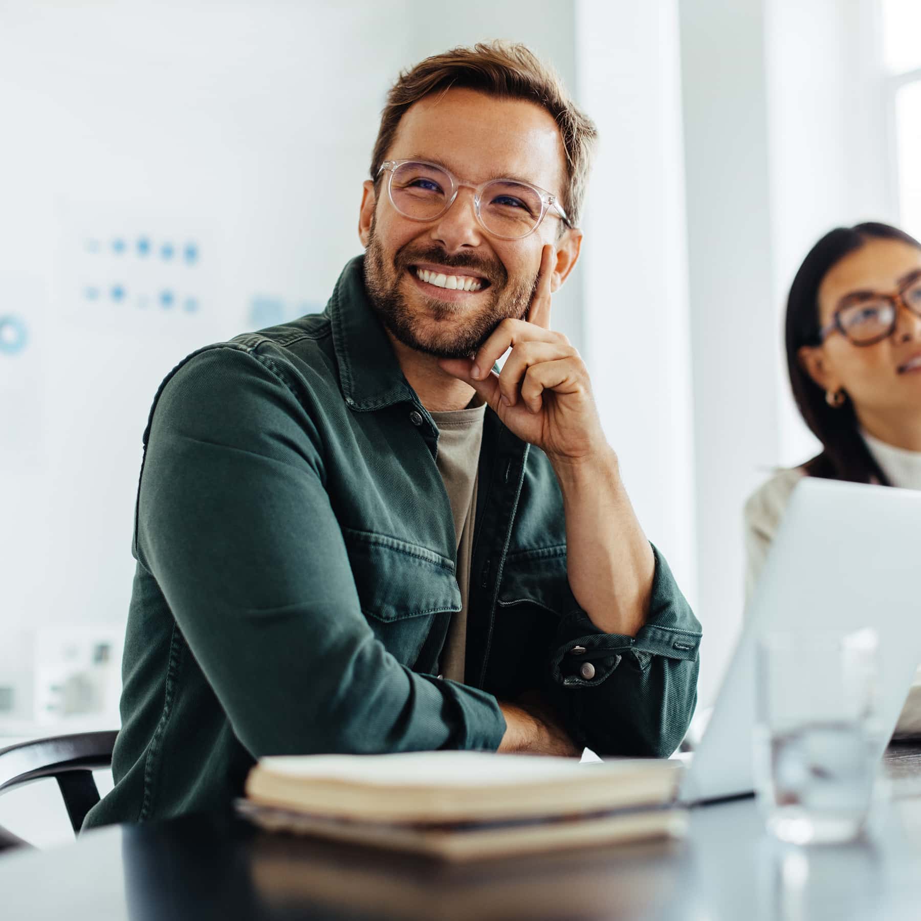 Man smiling with hand on face