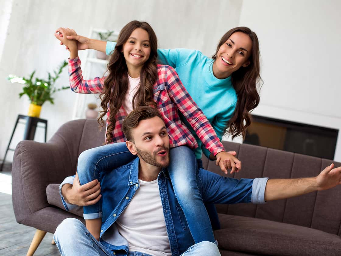 Happy family on the couch in living room 