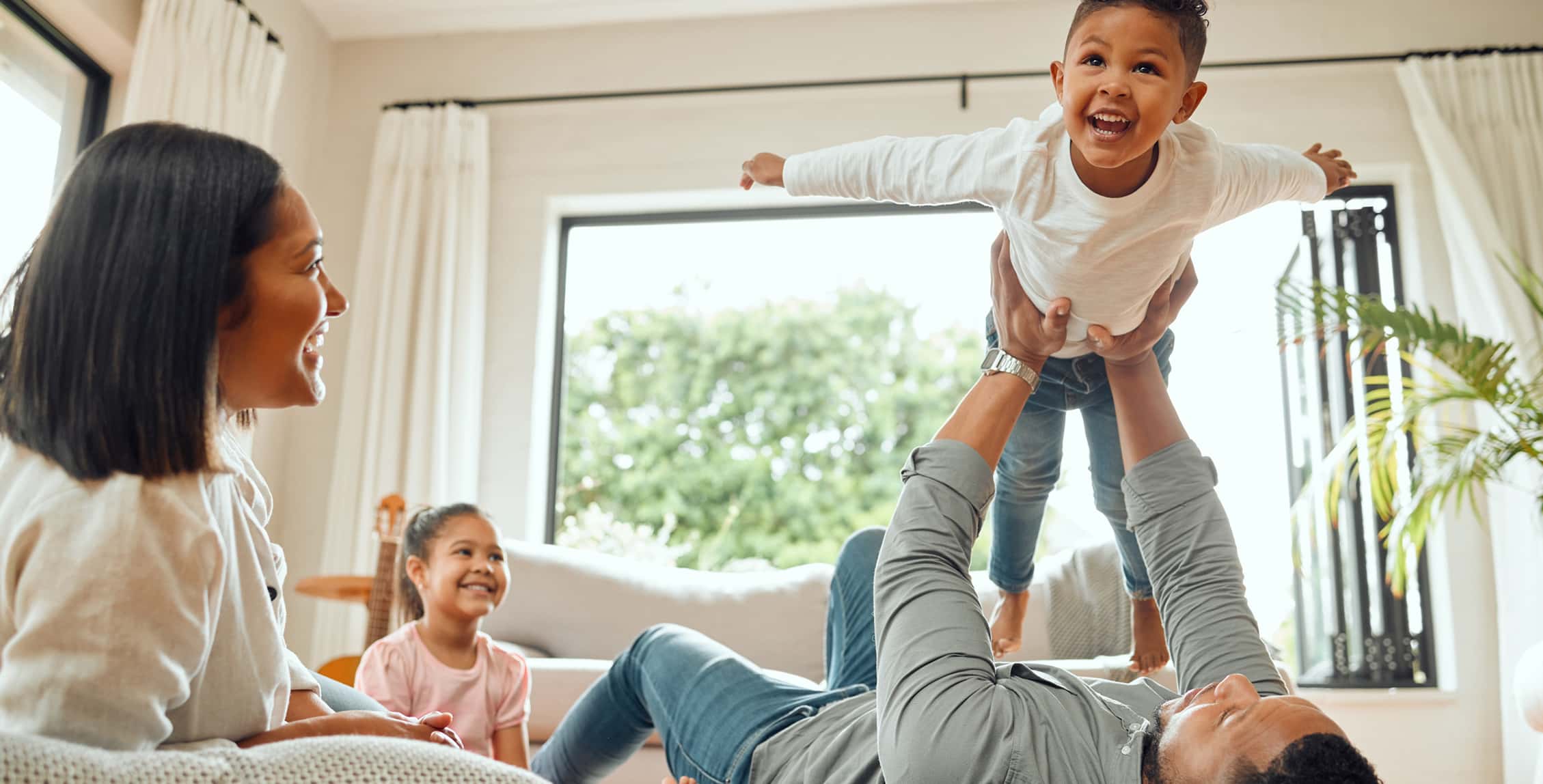 Shot of a young family playing together on the lounge floor at home