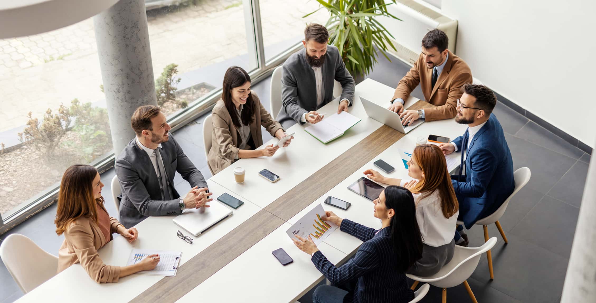 Group of businesspeople sitting at boardroom and discussing different insurance options. 
